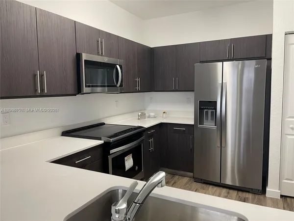 a kitchen with a sink a stove and refrigerator