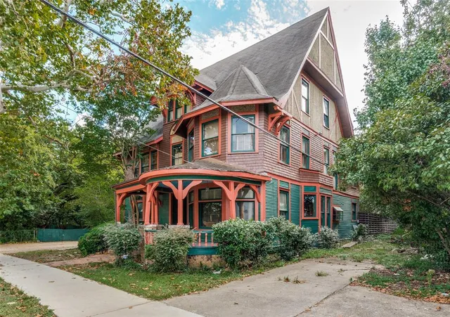 a front view of a house with yard and trees