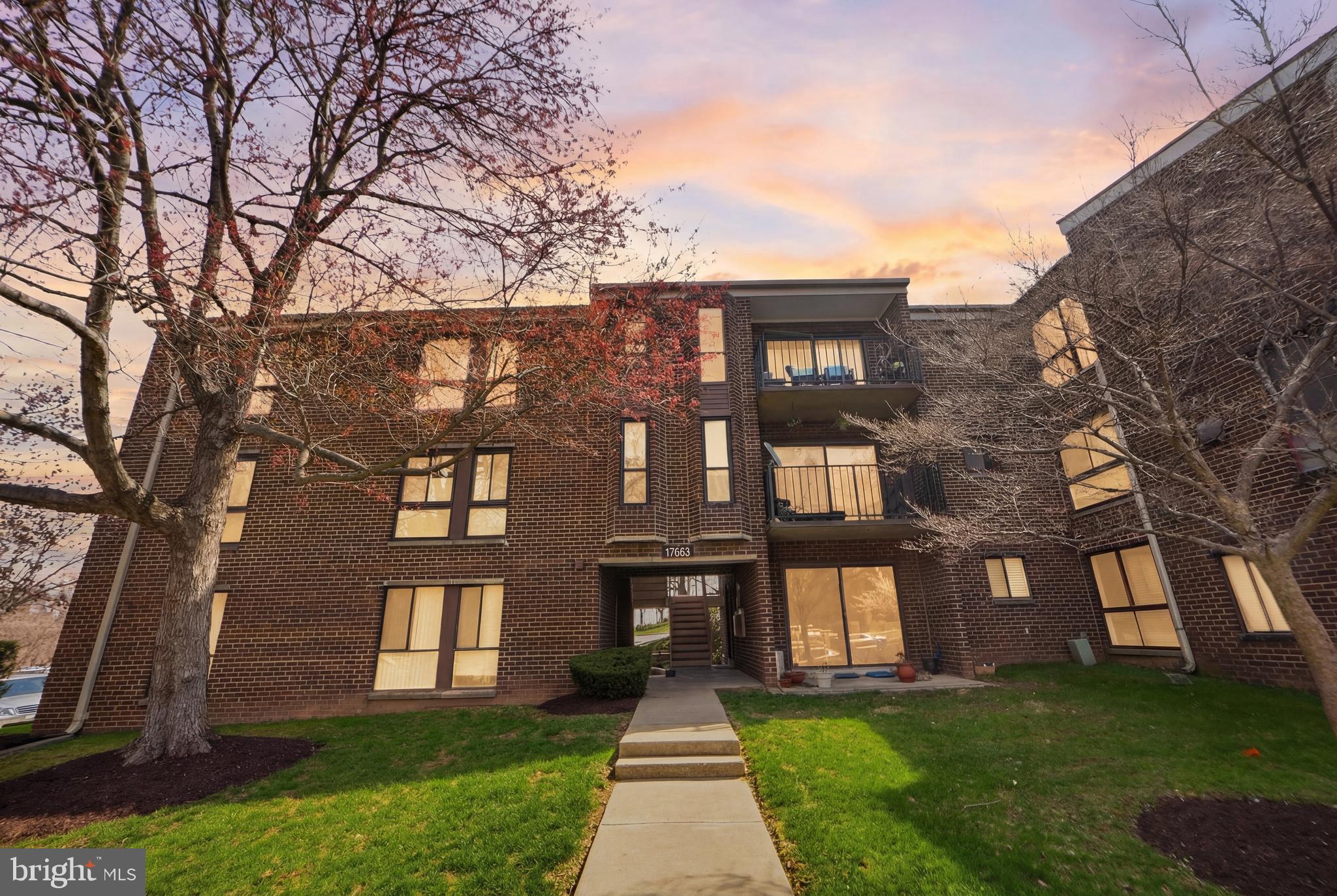 a front view of brick house with a yard
