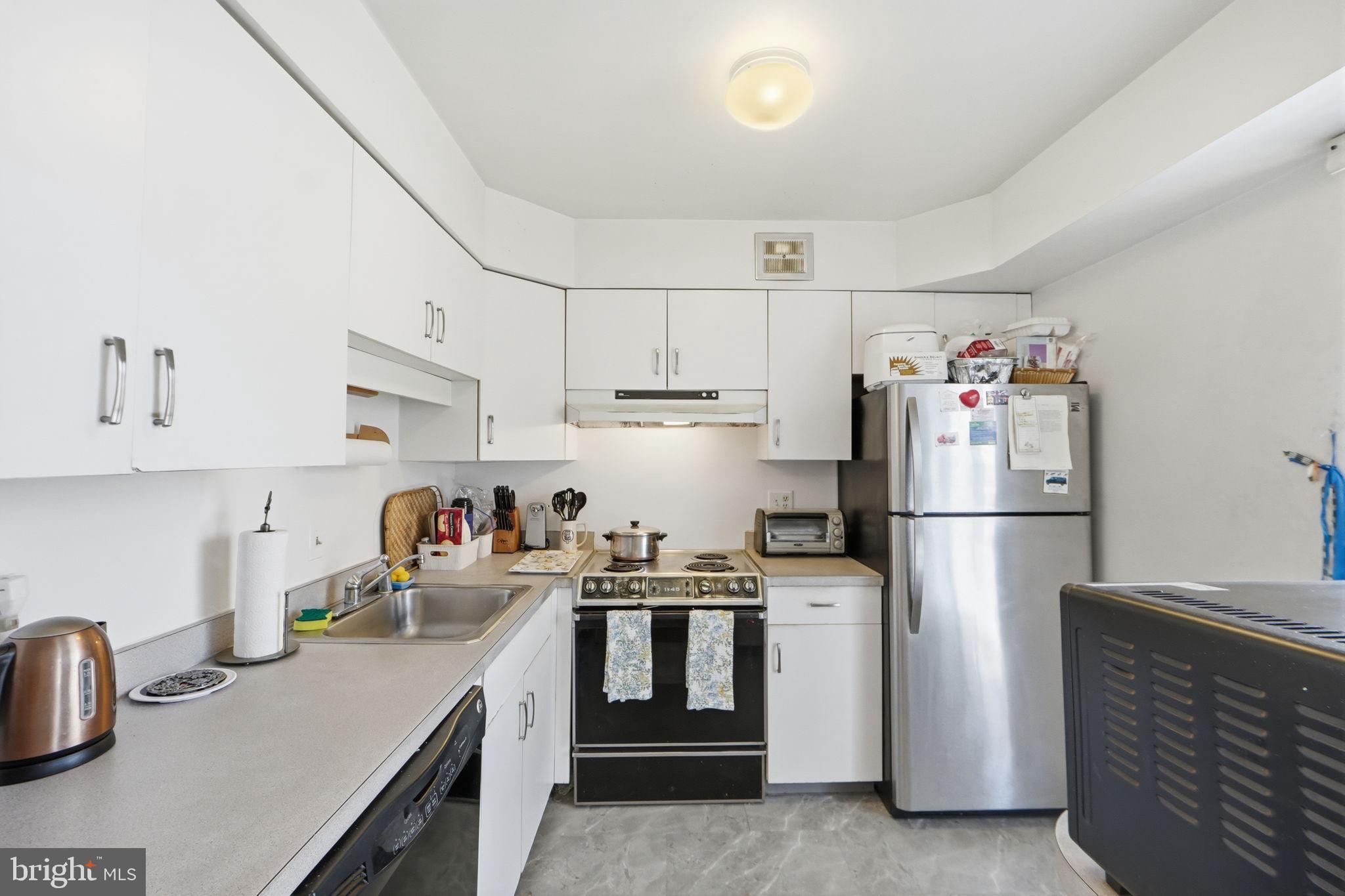 17805 Buehler Road, Unit 3 Olney, MD 20832 - Photo 15 of 30 a kitchen with refrigerator a stove a sink and cabinets
