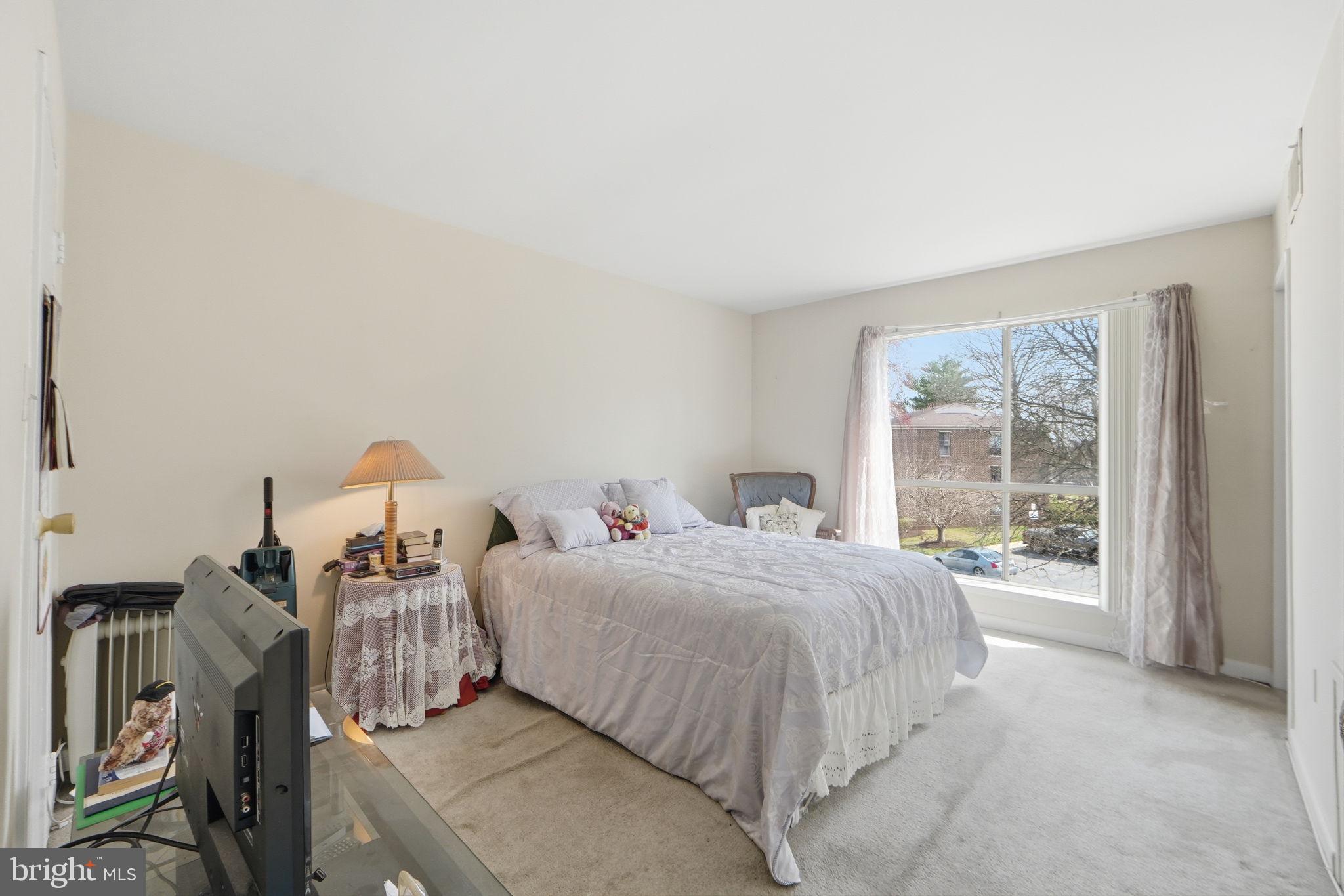 17805 Buehler Road, Unit 3 Olney, MD 20832 - Photo 19 of 30 a bedroom with a bed and a large window
