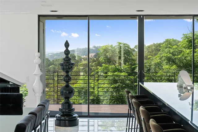 a view of a balcony with chairs and potted plants