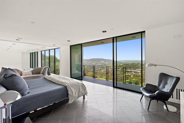 a bedroom with a bed and glass window
