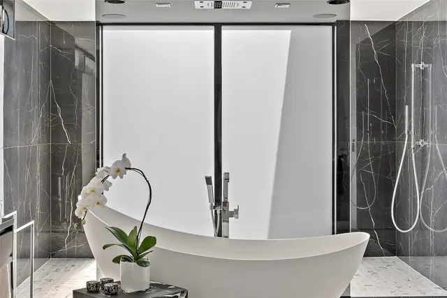 a bathroom with a shower and a mirror