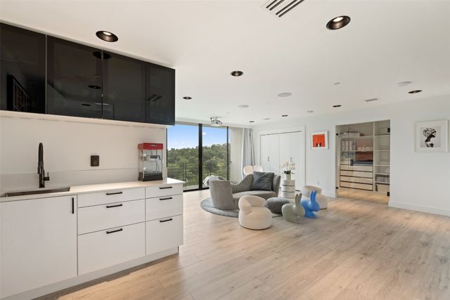a kitchen with stainless steel appliances kitchen island granite countertop a sink and cabinets