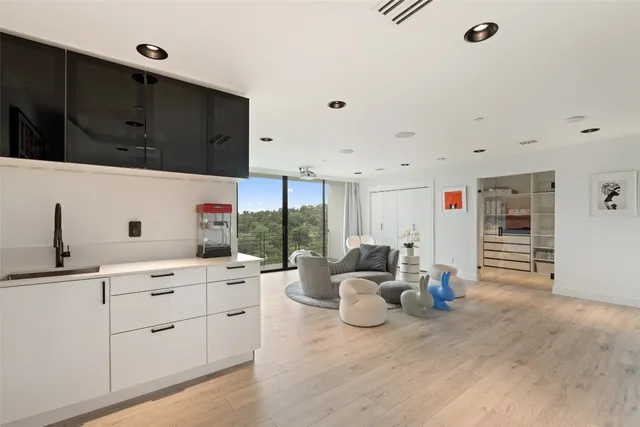 a kitchen with stainless steel appliances kitchen island granite countertop a sink and cabinets