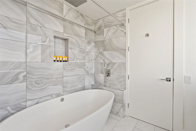 a bathroom with a bathtub and shower