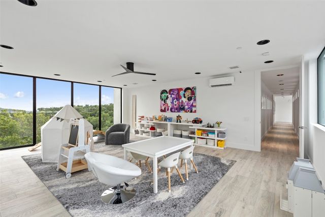 a living room with furniture and a floor to ceiling window
