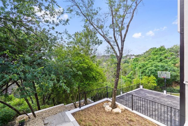 a view of a backyard with large trees