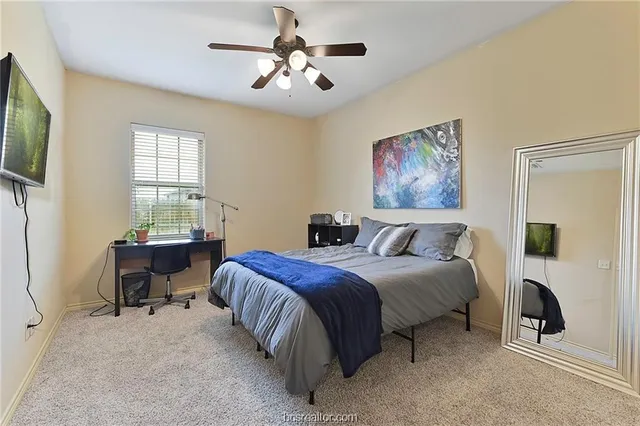 a spacious bedroom with a bed and a table in it