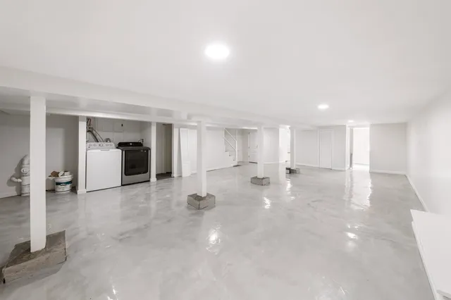 a view of a white house with wooden fence