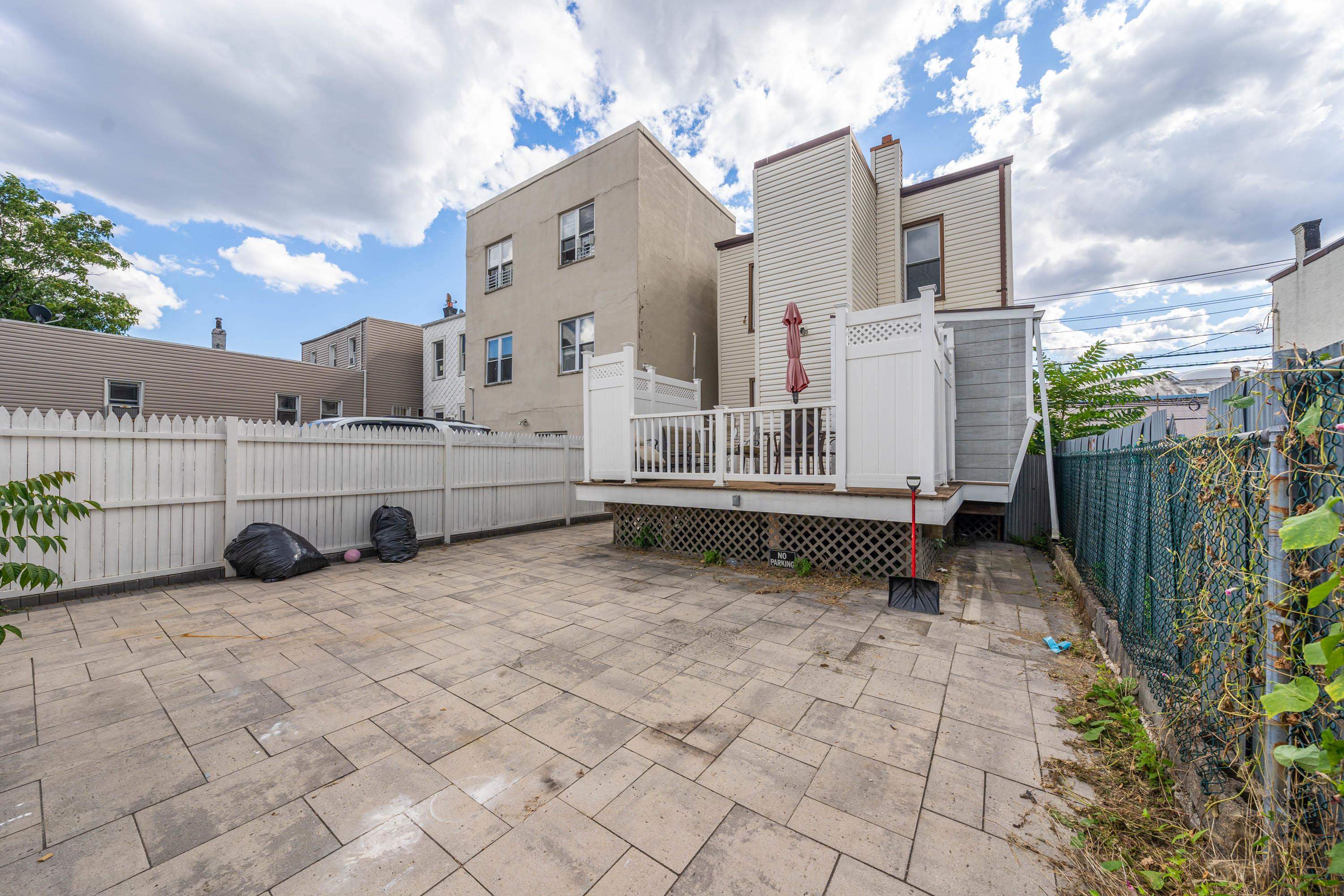600 67th Street, Unit 1 & LL West New York, NJ 07093 - Photo 22 of 29 a view of a white house with wooden fence