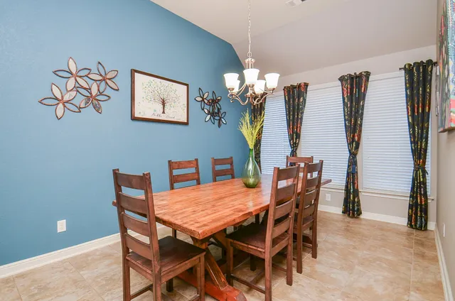 a dining room with furniture and window