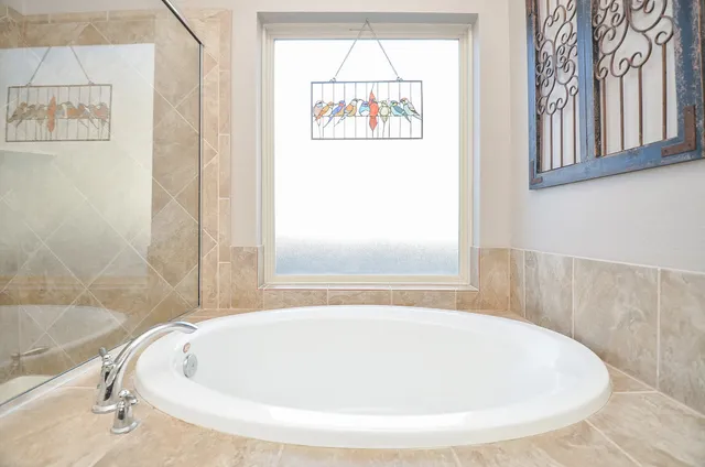 a white bath tub sitting next to a window