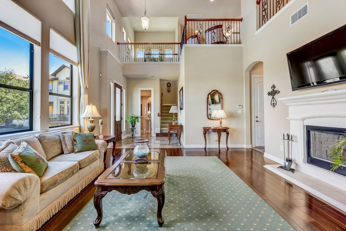 a living room with furniture a fireplace and a flat screen tv