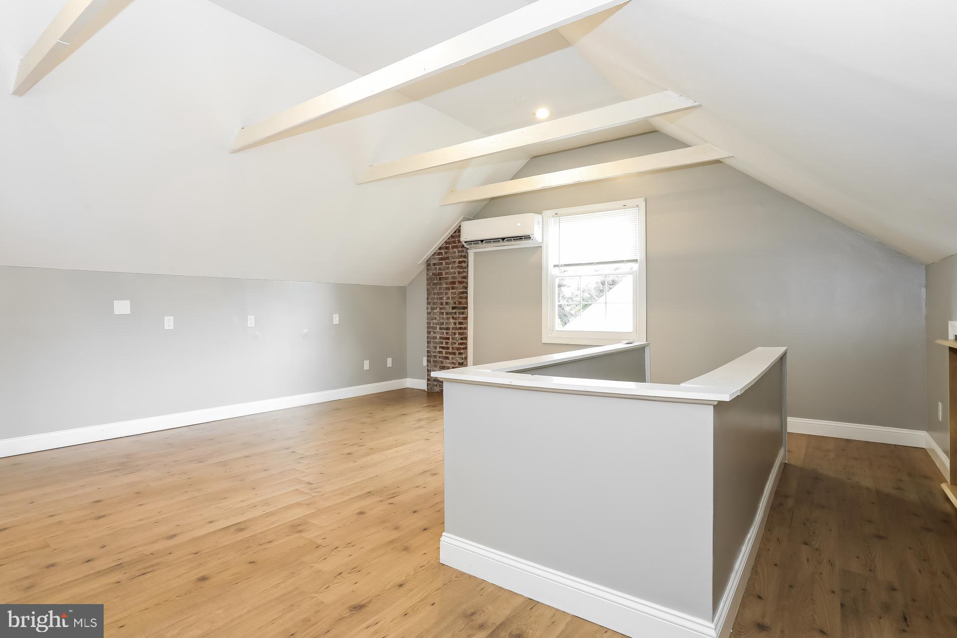 6207 Eastern Parkway Baltimore, MD 21206 - Photo 11 of 15 wooden floor in an empty room with a window