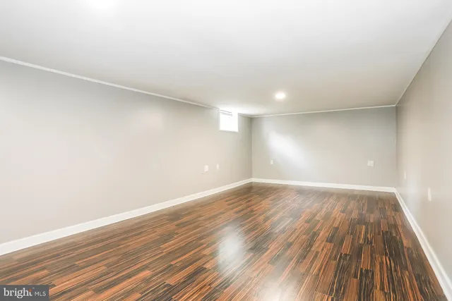a view of an empty room and wooden floor
