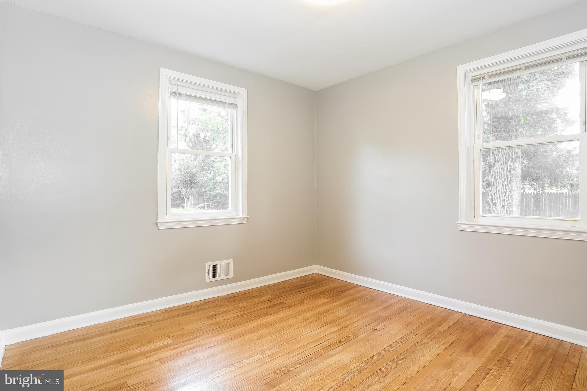 6207 Eastern Parkway Baltimore, MD 21206 - Photo 8 of 15 a view of a room with wooden floor and windows