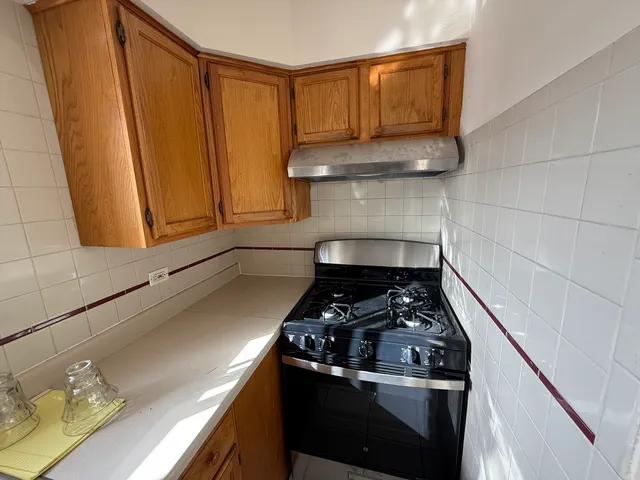 a kitchen with a stove a sink and cabinets