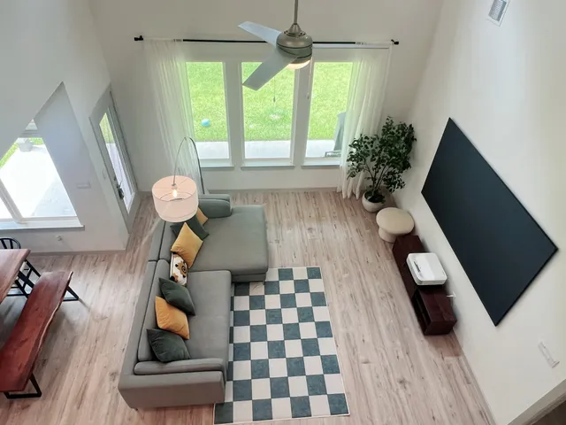 a living room with furniture and a large window