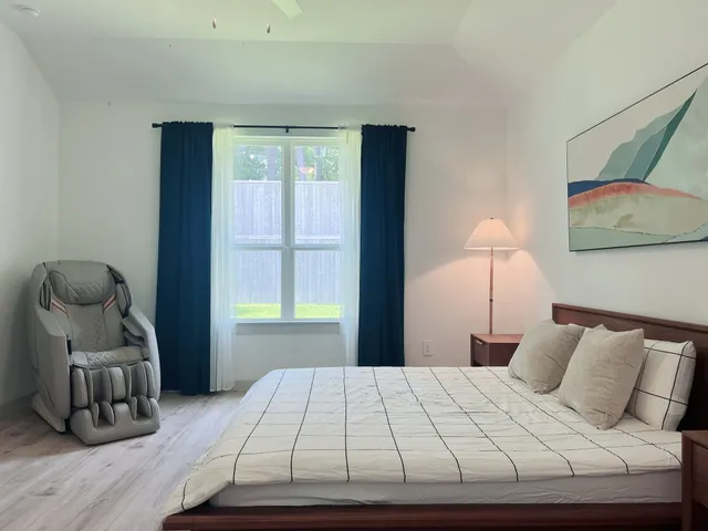 a bedroom with a bed and a chair