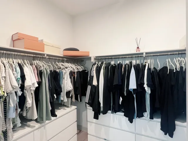 a view of walk in closet with clothes and shoes