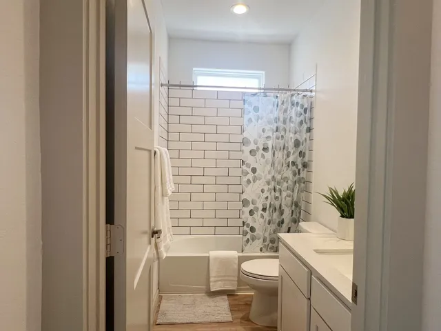 a bathroom with a toilet a sink and shower