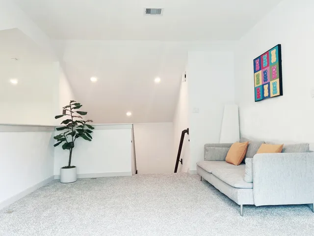 a living room with furniture and a potted plant