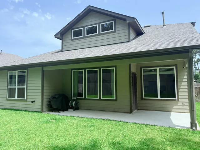 a view of a house with a yard and large window