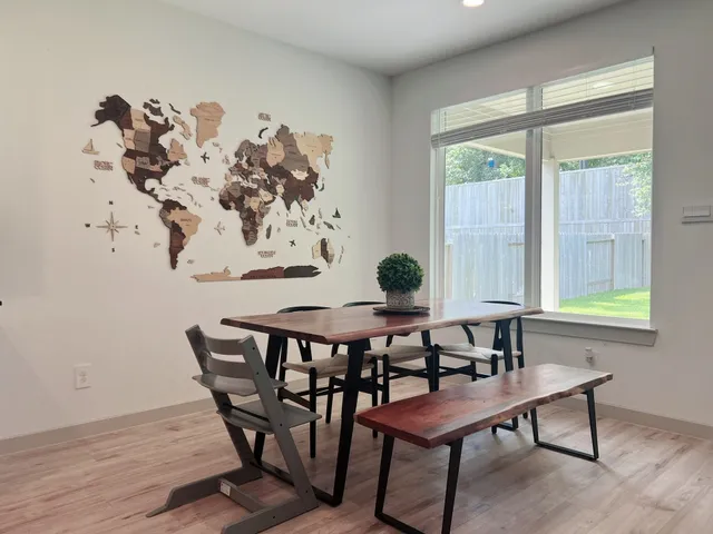 a view of a dining room with furniture and window