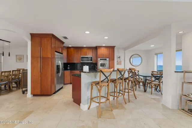 a kitchen with stainless steel appliances granite countertop a stove and a sink