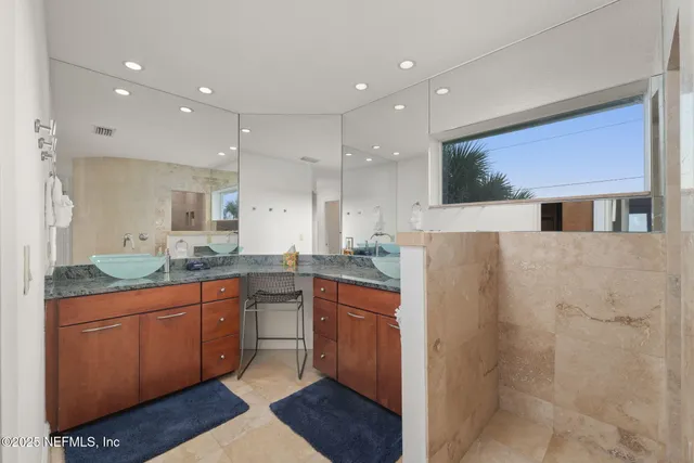 a bedroom with two beds and a large window