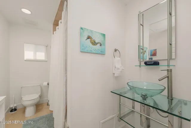 a bedroom with a large bed and a large window