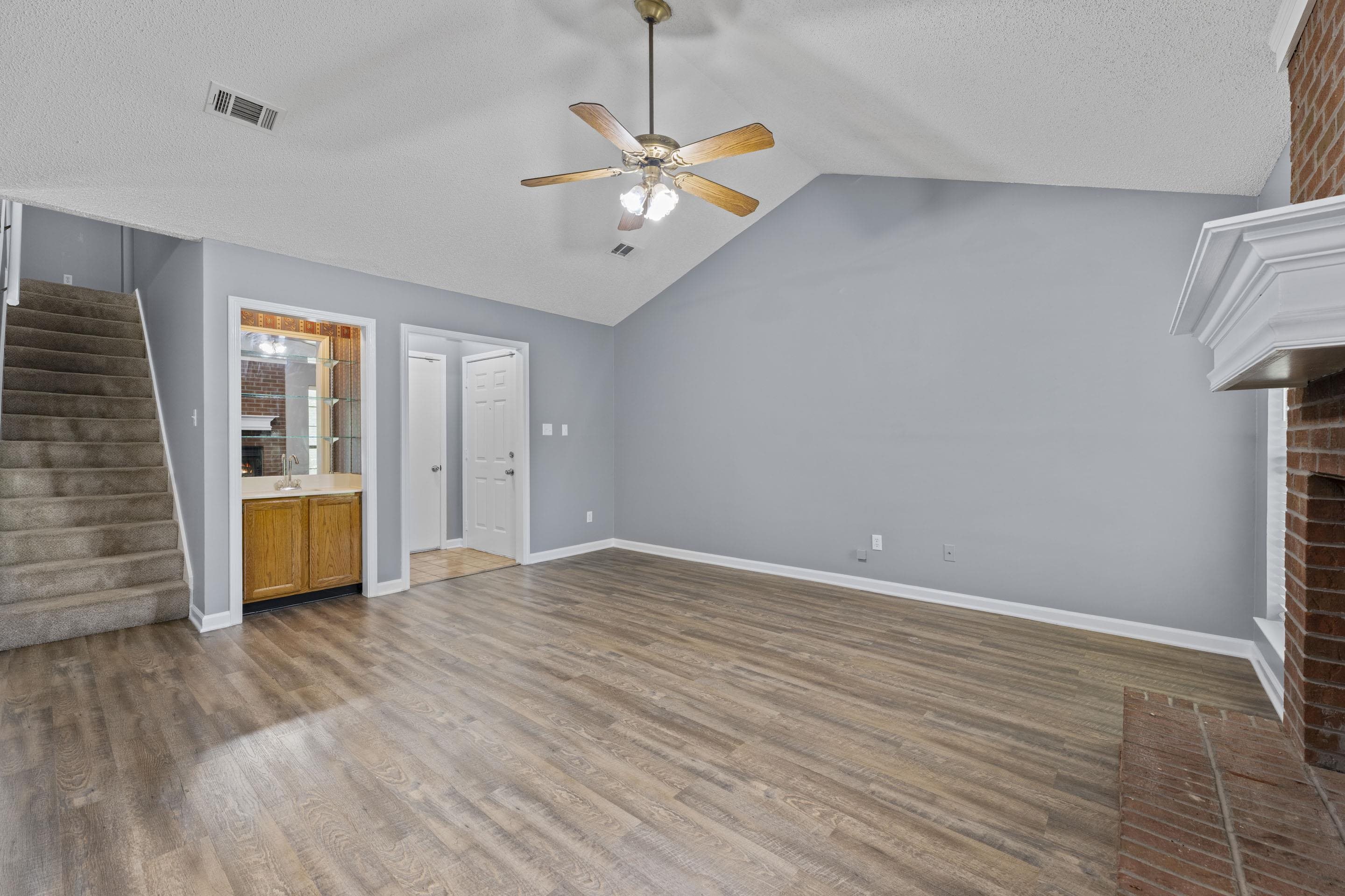 2252 Mangum Road Memphis, TN 38134 - Photo 5 of 23 Wood-finish flooring, vaulted ceiling, and a ceiling fan with light fixture