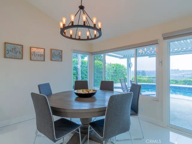 a view of a dining room with furniture wooden floor and chandelier