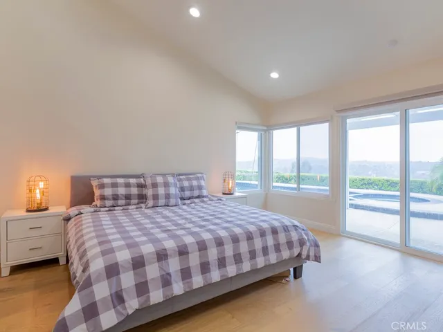 a bedroom with a large bed and a large window