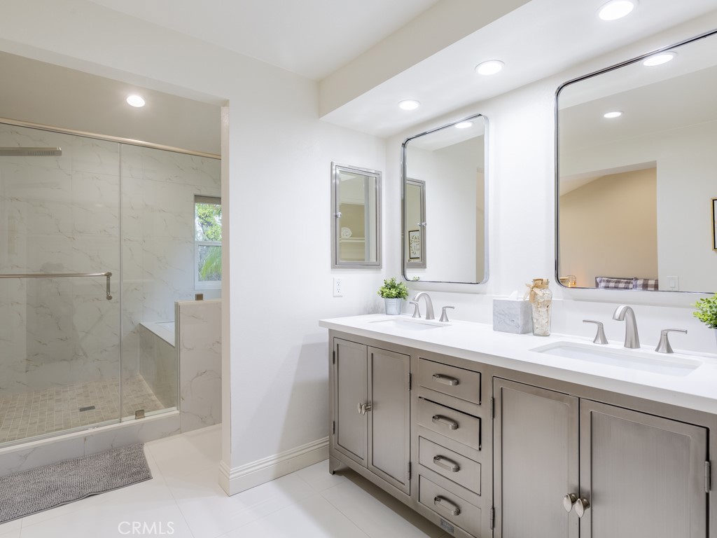 3305 Hawkwood Road Diamond Bar, CA 91765 - Photo 23 of 32 a bathroom with a granite countertop bathtub shower sink double and mirror