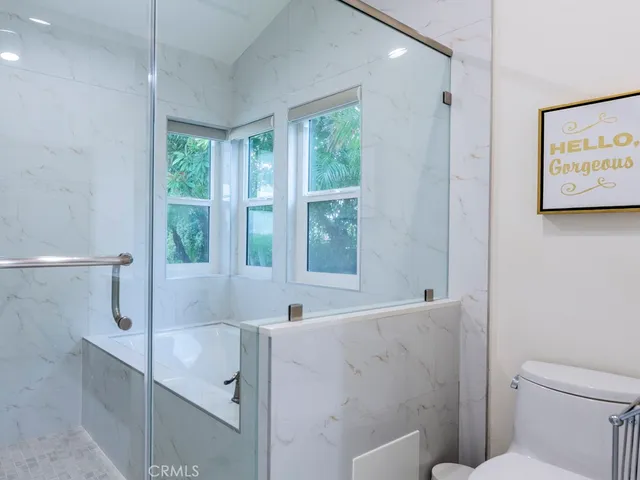 a bathroom with a bathtub and next to a window