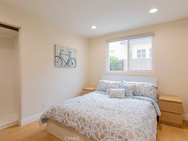 a bedroom with a large bed and a window