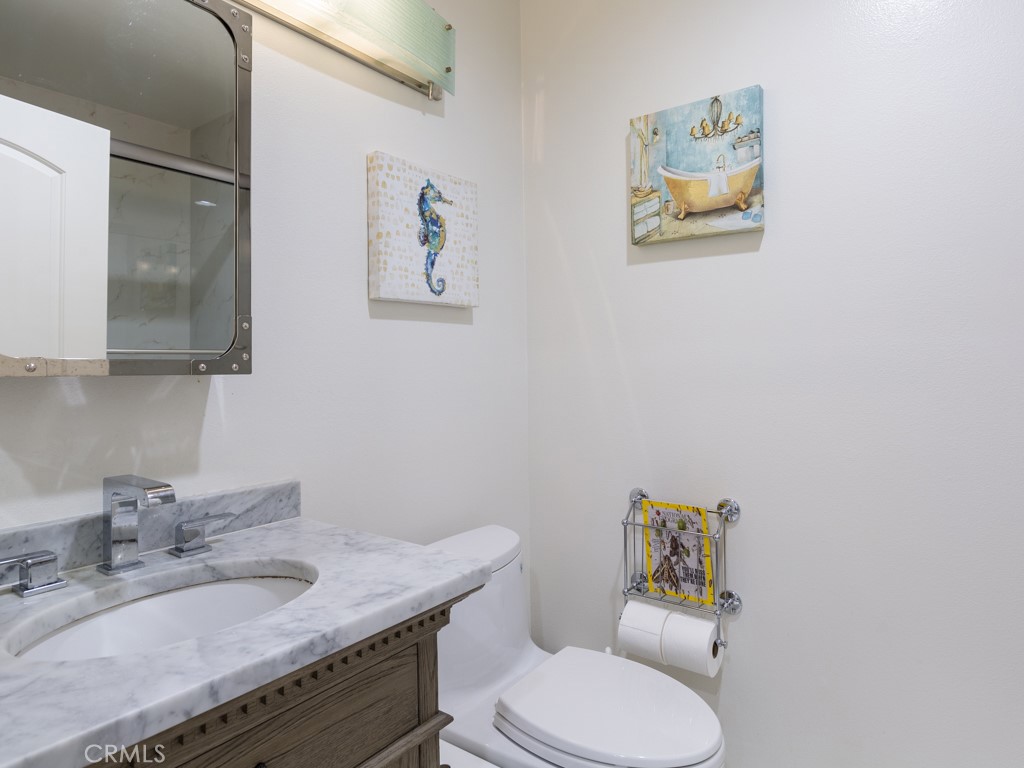 3305 Hawkwood Road Diamond Bar, CA 91765 - Photo 28 of 32 a bathroom with a granite countertop toilet sink and mirror
