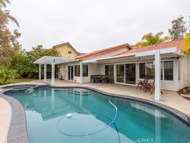 a view of a house with swimming pool and porch