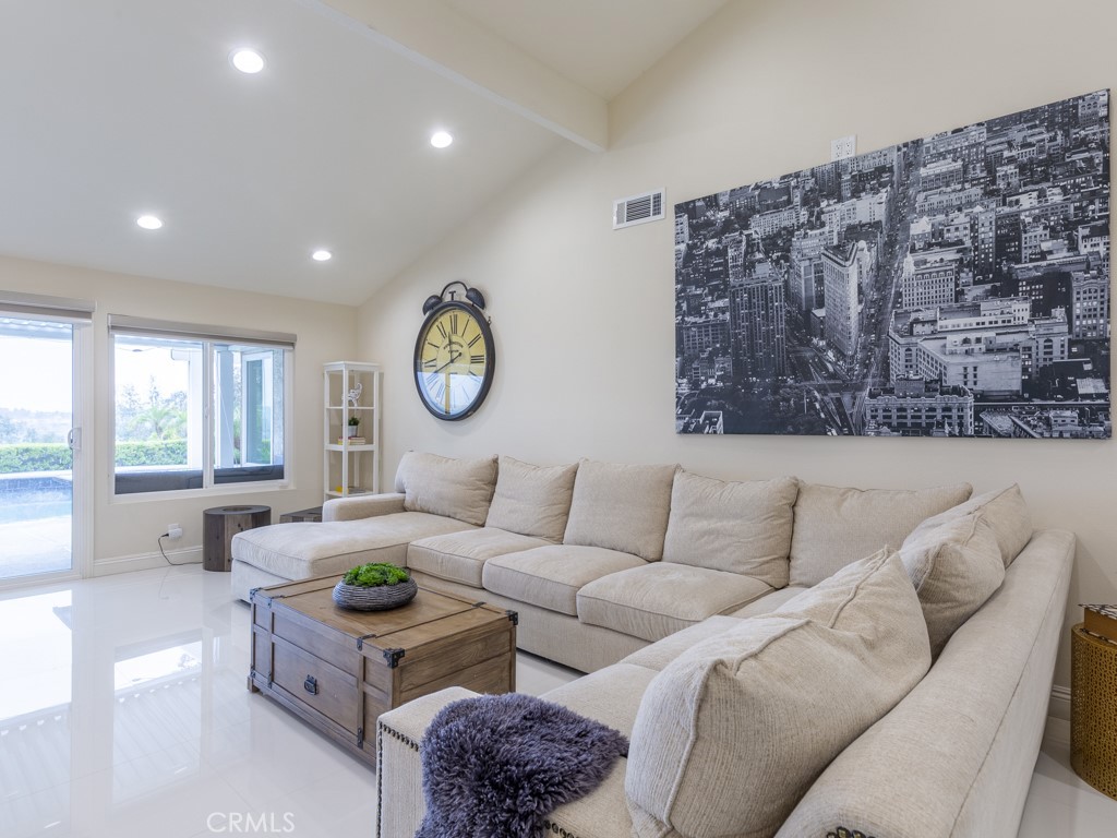 3305 Hawkwood Road Diamond Bar, CA 91765 - Photo 3 of 32 a living room with a couch a large window and a clock