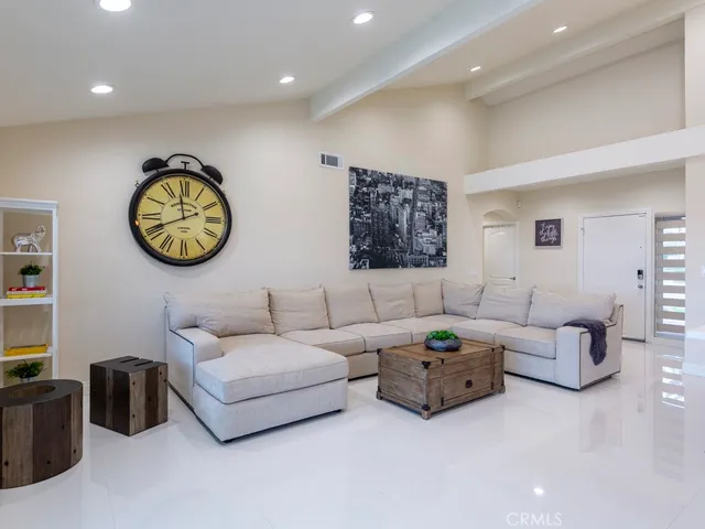 a living room with furniture a wall painting and a wall painting