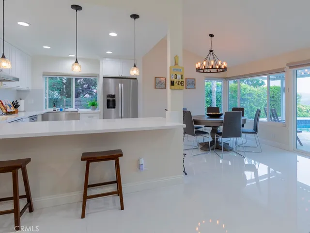 a large kitchen with a table and chairs