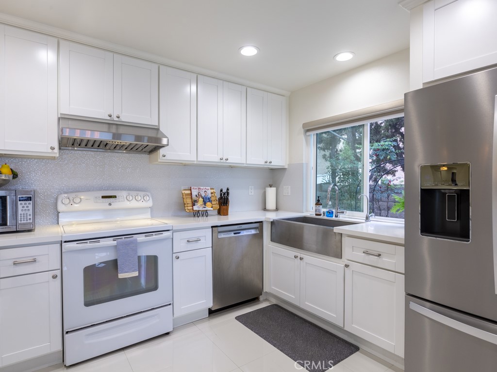 3305 Hawkwood Road Diamond Bar, CA 91765 - Photo 10 of 32 a kitchen with granite countertop white cabinets and white appliances