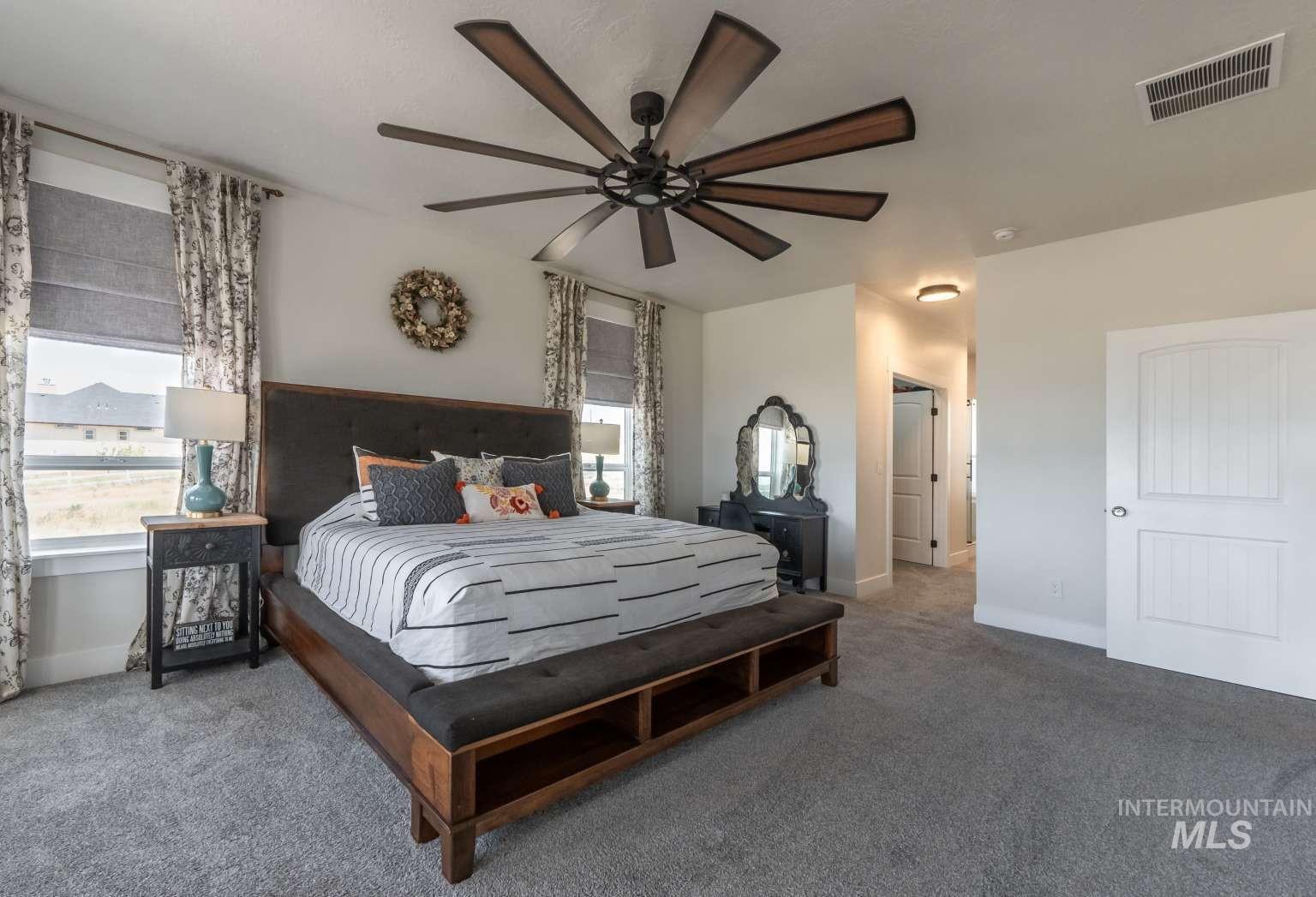 9853 Salmon Ridge Place Nampa, ID 83686 - Photo 11 of 48 Carpeted bedroom with ceiling fan and baseboards
