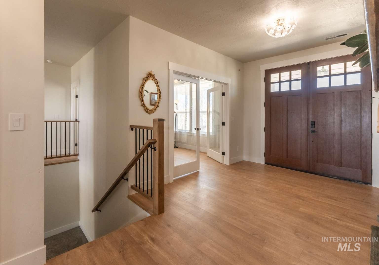 9853 Salmon Ridge Place Nampa, ID 83686 - Photo 16 of 48 Foyer featuring plenty of natural light and wood finished floors