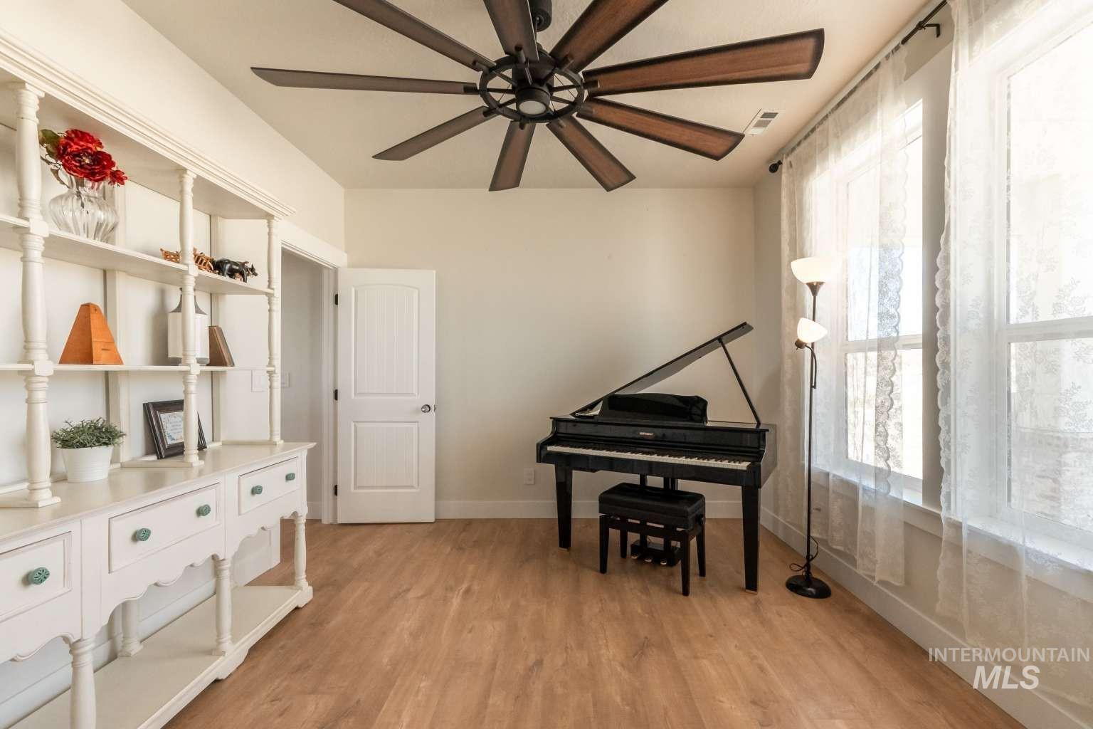 9853 Salmon Ridge Place Nampa, ID 83686 - Photo 17 of 48 Living area with light wood finished floors and a ceiling fan