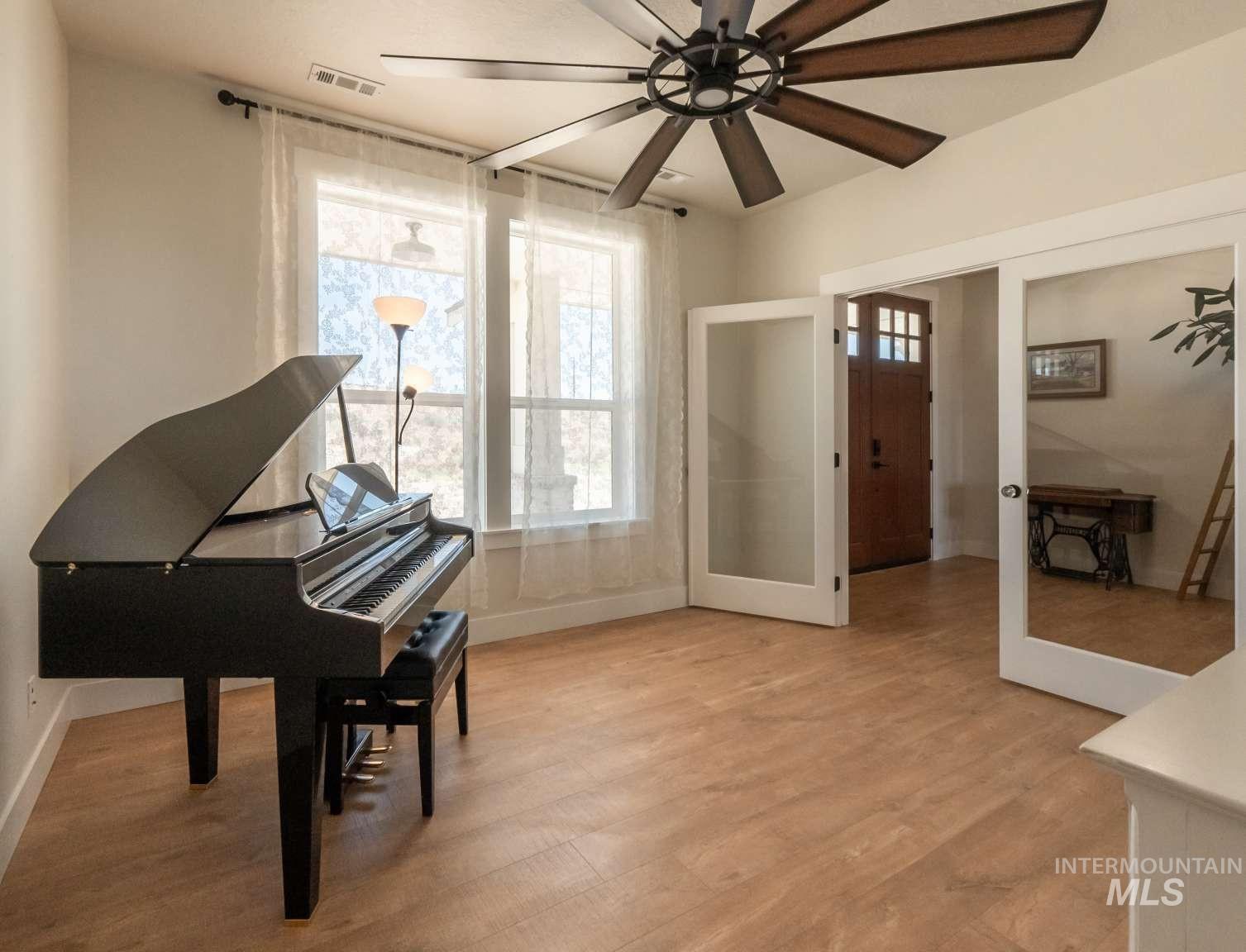 9853 Salmon Ridge Place Nampa, ID 83686 - Photo 18 of 48 Sitting room featuring light wood finished floors, ceiling fan, and french doors