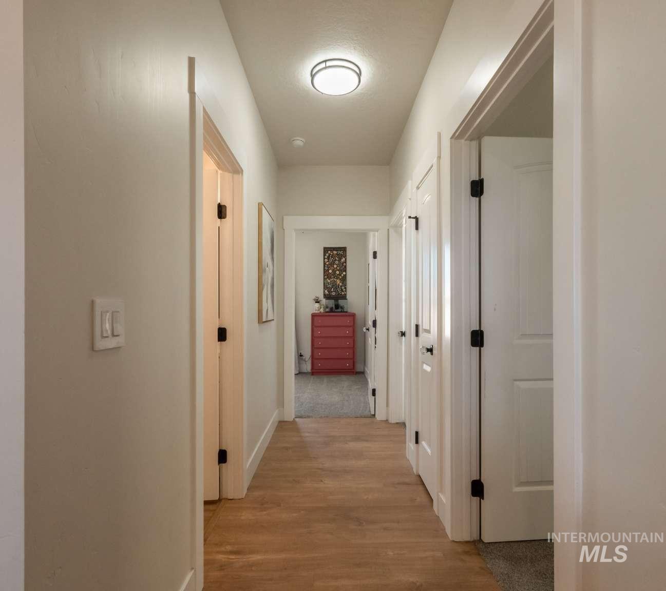 9853 Salmon Ridge Place Nampa, ID 83686 - Photo 20 of 48 Corridor with light wood-style floors and baseboards
